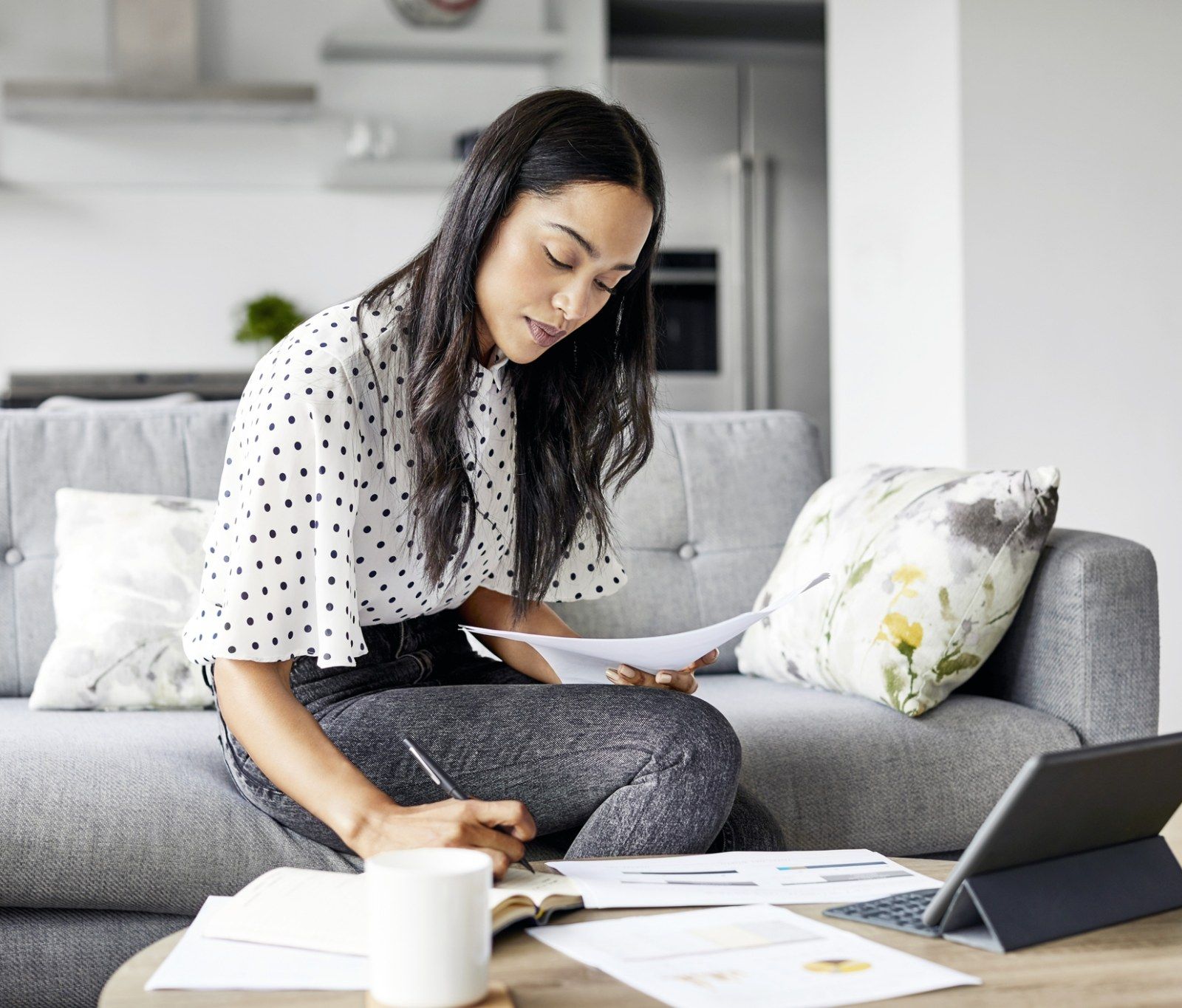 Woman at home evaluating her finances