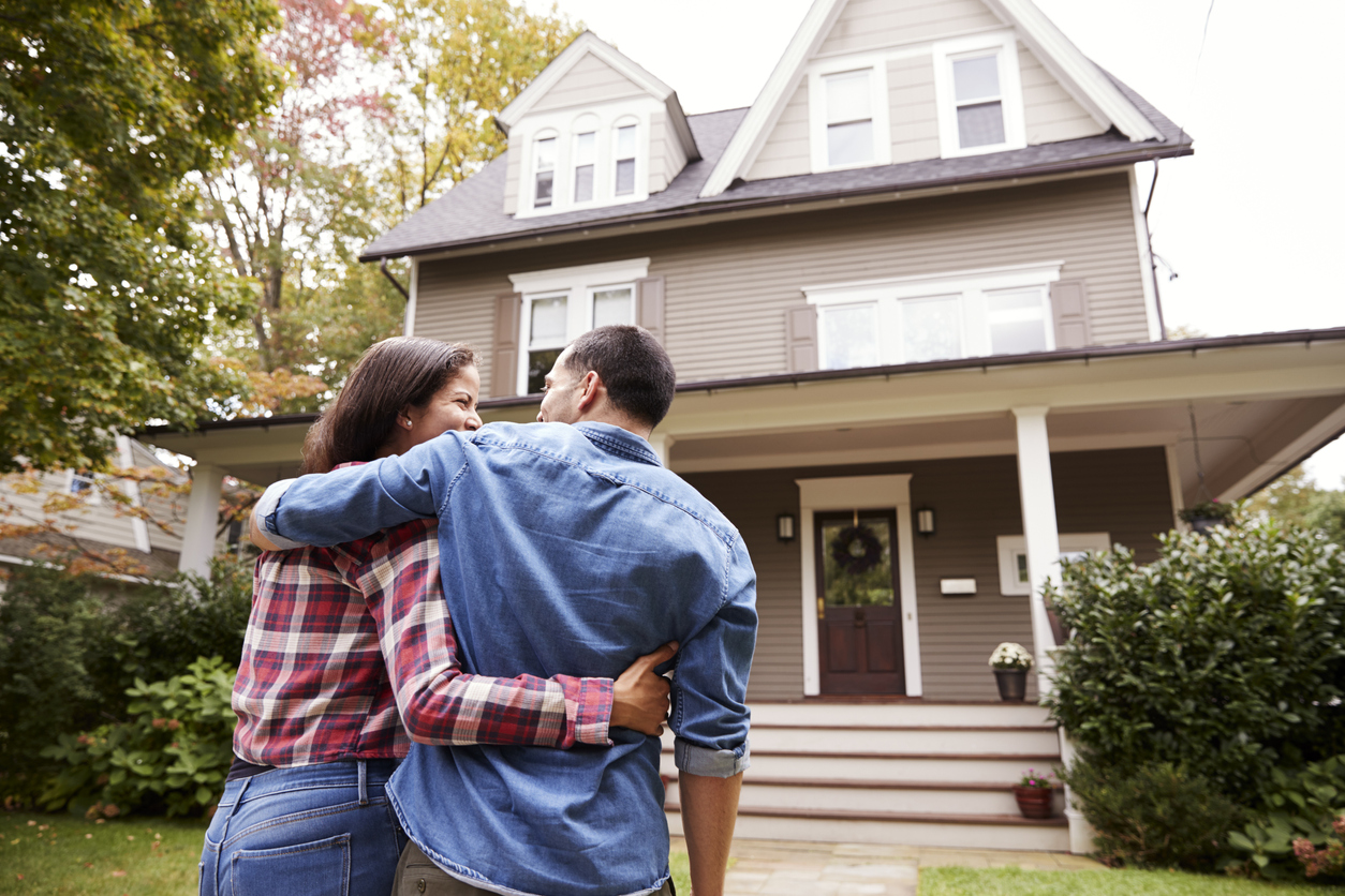 couple in front of their new home