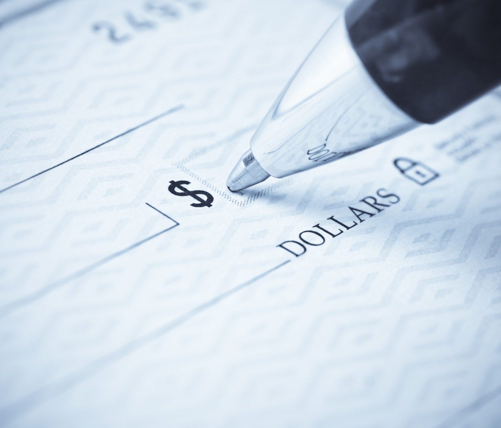 A close up of a pen filling out the dollar amount portion of a check