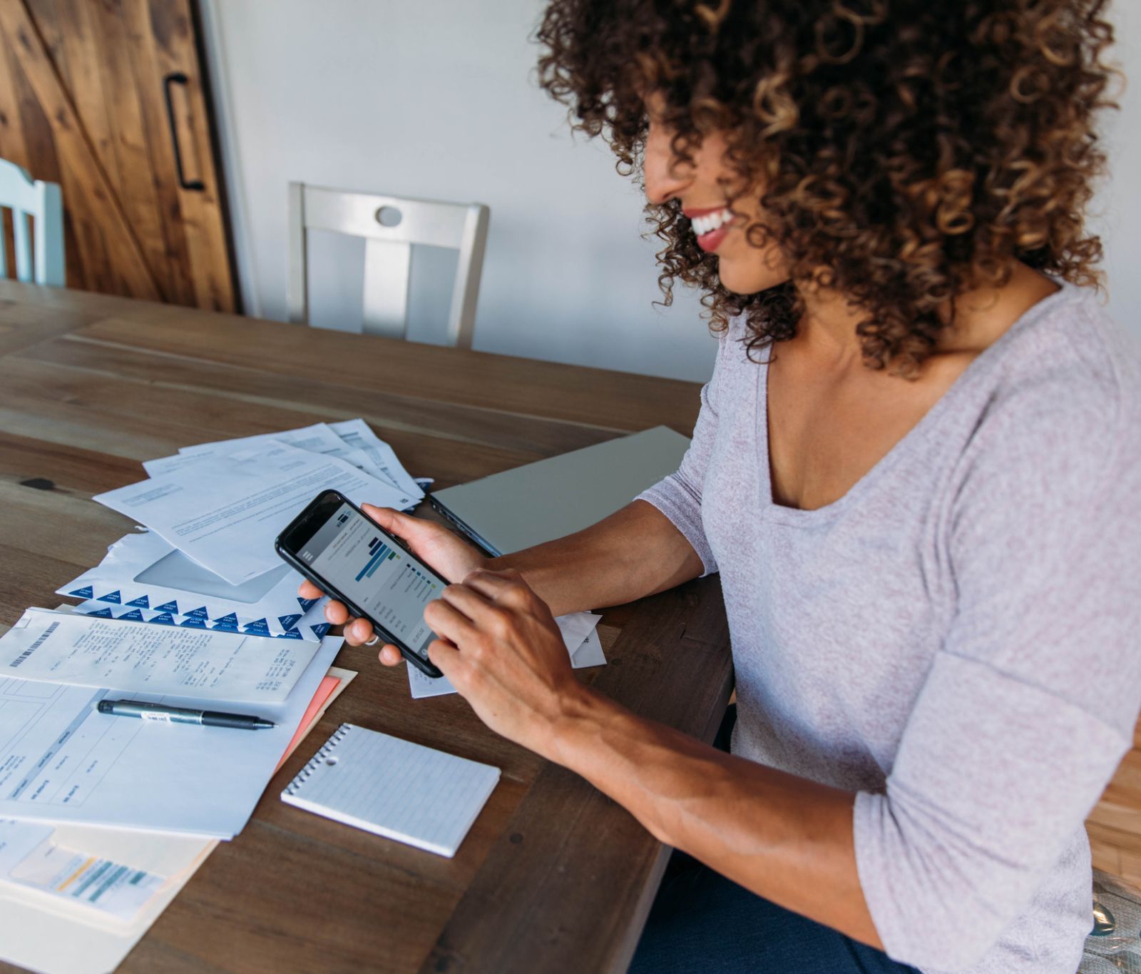 A woman looking up her mobile banking expenses on her phone