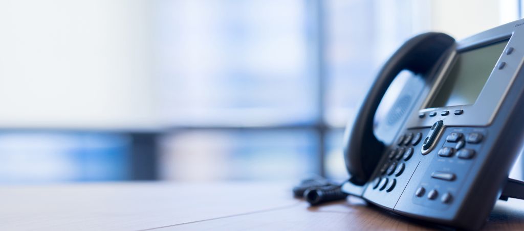 A close up of a landline telephone in an office