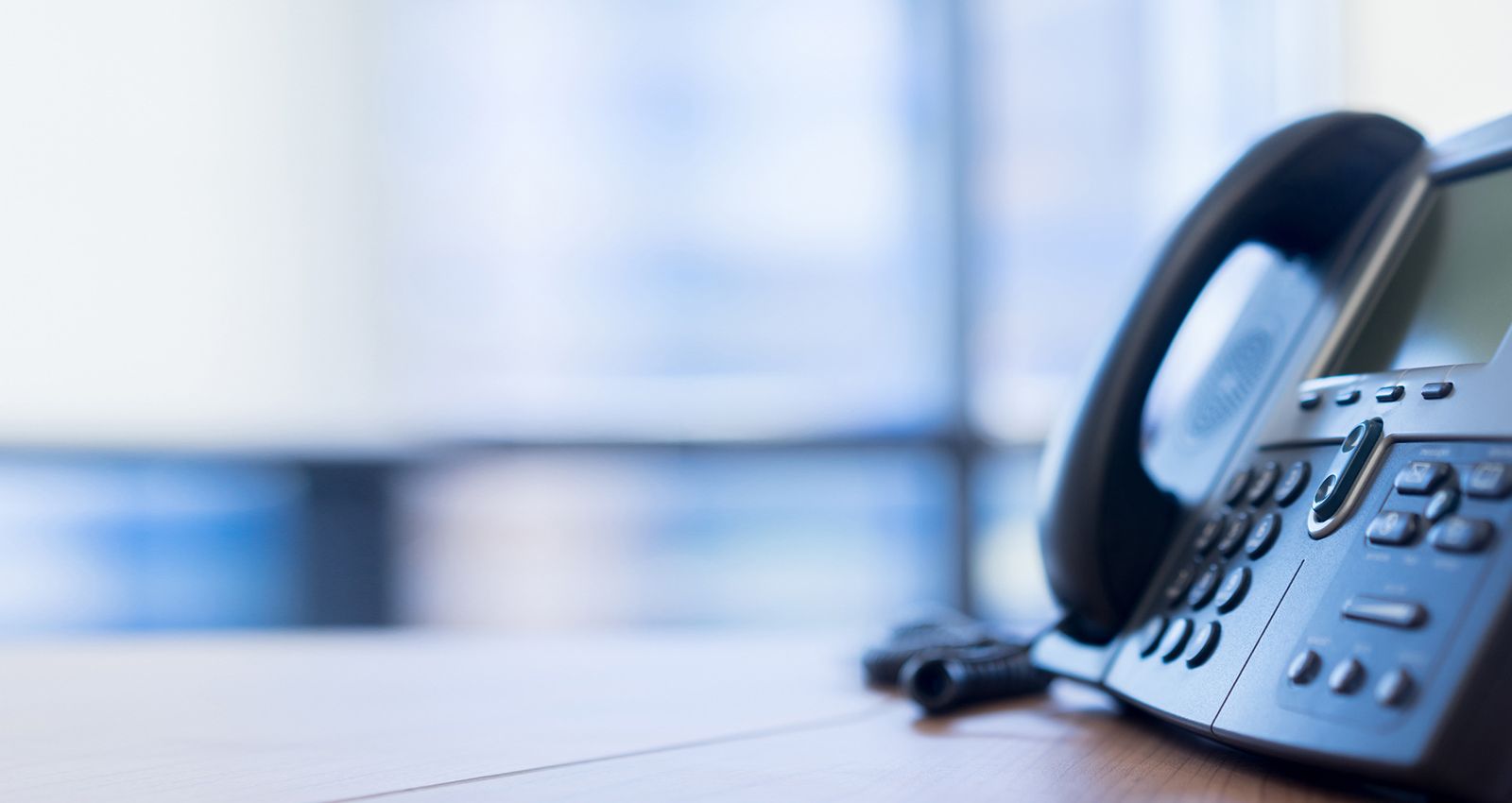 A close up of a landline telephone in an office