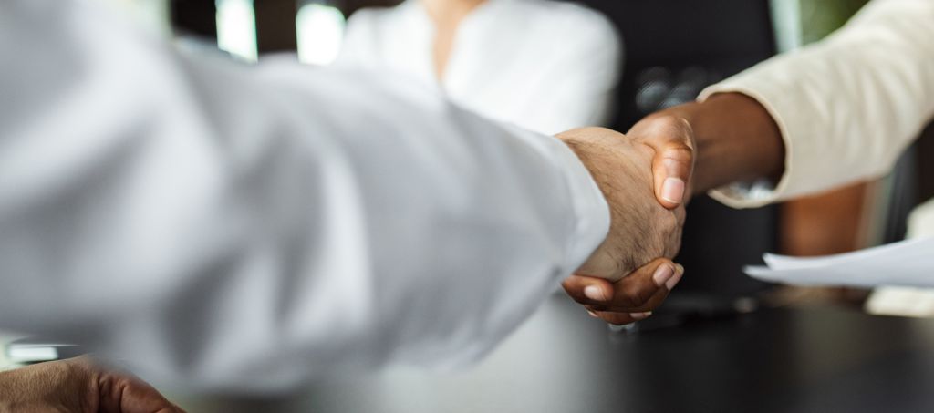 Businesswoman shaking hands with a man
