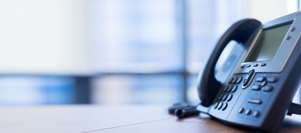 A close up of a landline telephone in an office