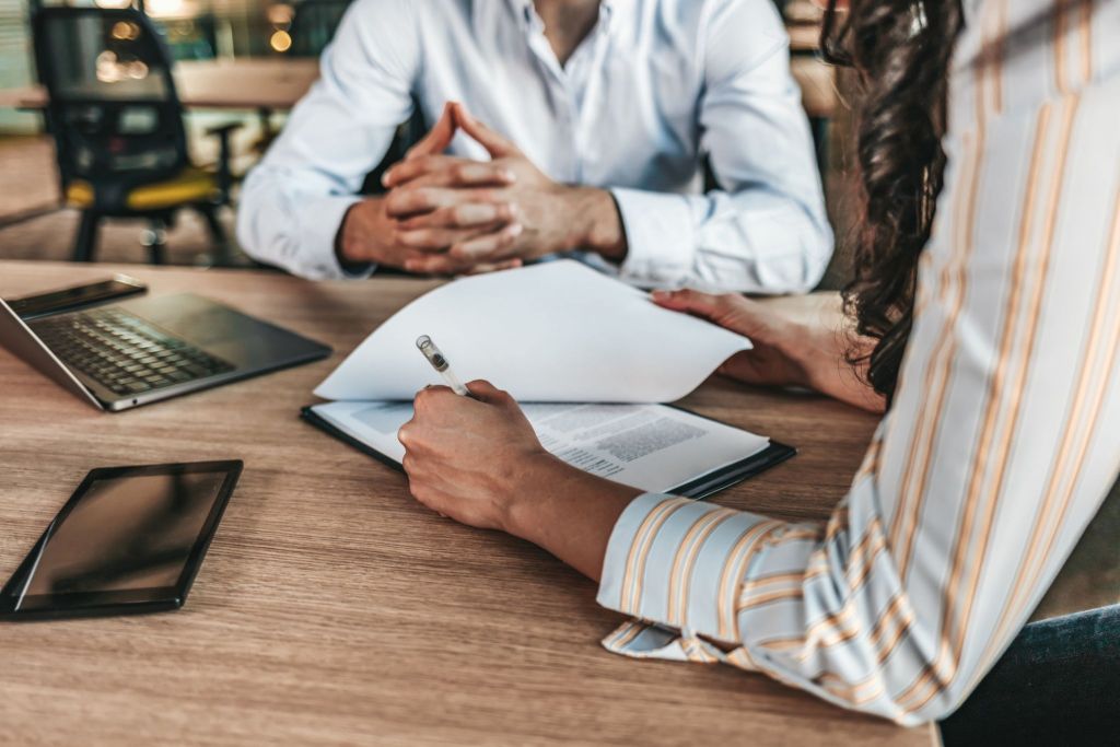 Female businessperson signs contract