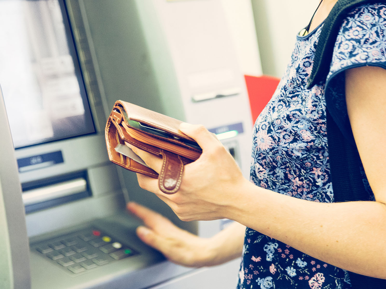 Woman withdrawing money from an ATM
