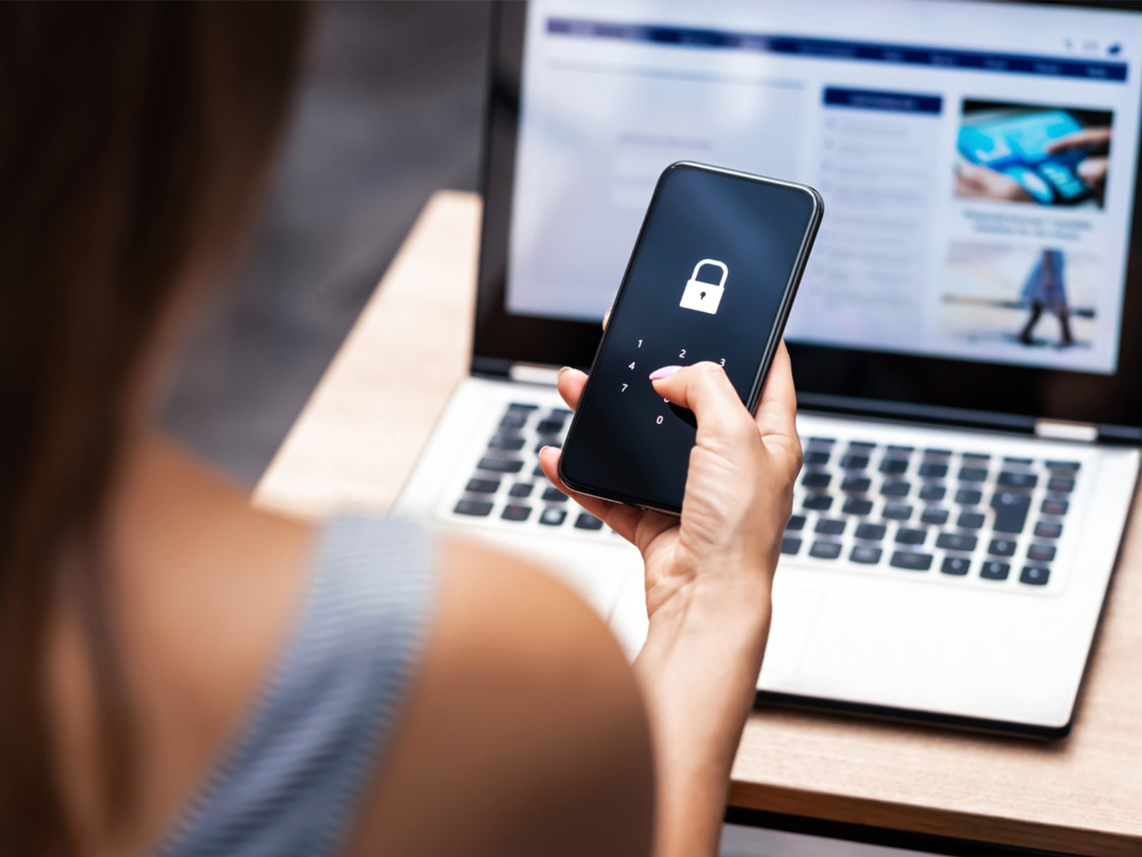 Woman typing password into phone