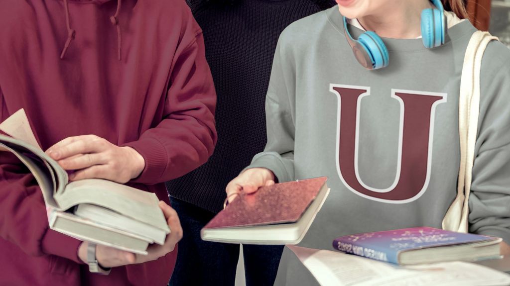 two students sharing books